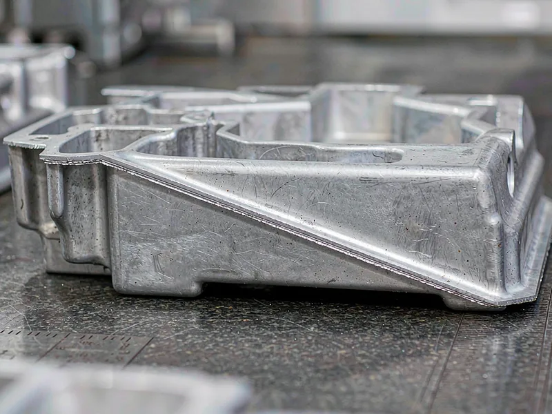 Aluminum die casting showing flash along its parting line