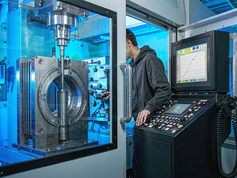 Operator reviewing shot velocity data on the die casting machine control panel